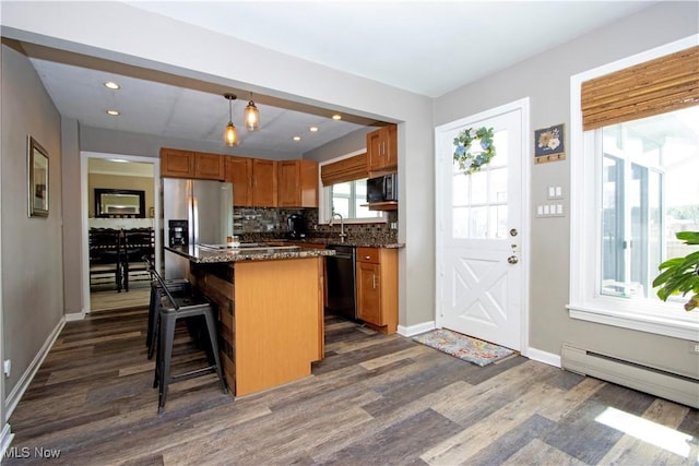 31 Morgan Ave, Ashland, OH 44805 - kitchen with a center island, a breakfast bar, stainless steel appliances, a baseboard radiator, and dark wood-style floors
