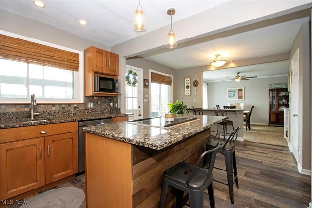 31 Morgan Ave, Ashland, OH 44805 - kitchen with a ceiling fan, a breakfast bar, a sink, stainless steel dishwasher, and black microwave