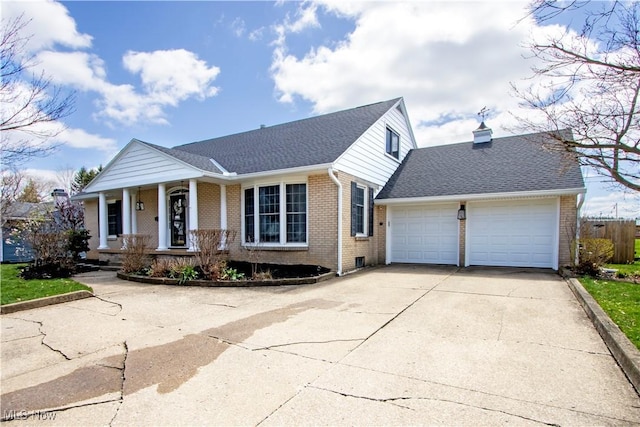 31 Morgan Ave, Ashland, OH 44805 - ranch-style house featuring concrete driveway, covered porch, brick siding, and a garage