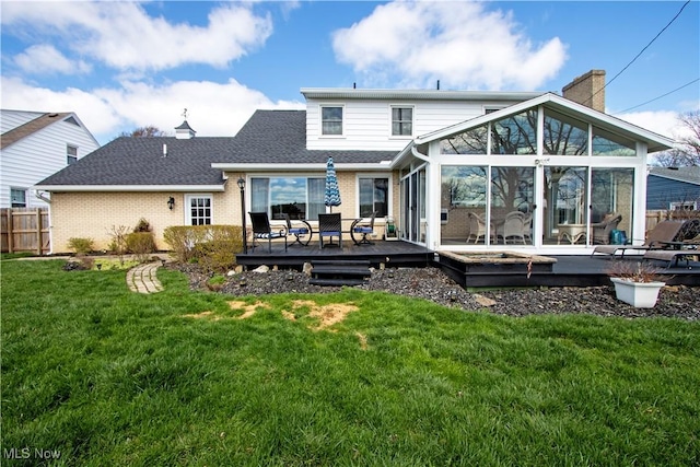 31 Morgan Ave, Ashland, OH 44805 - rear view of house with a sunroom, a chimney, fence, a wooden deck, and brick siding