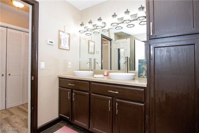 31 Morgan Ave, Ashland, OH 44805 - bathroom featuring a sink, double vanity, a closet, and baseboards