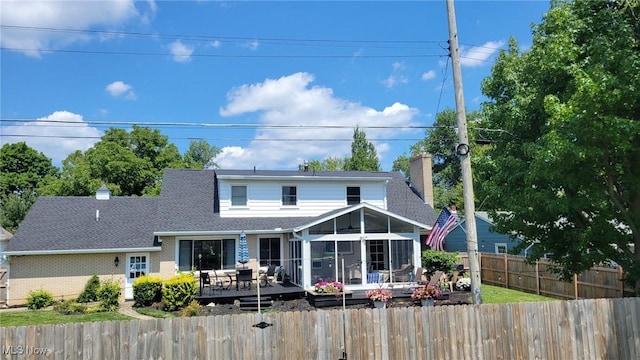 31 Morgan Ave, Ashland, OH 44805 - rear view of property featuring a deck, brick siding, a fenced backyard, a sunroom, and a shingled roof