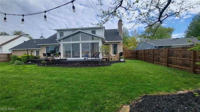31 Morgan Ave, Ashland, OH 44805 - rear view of property featuring a sunroom, a chimney, a lawn, and a fenced backyard