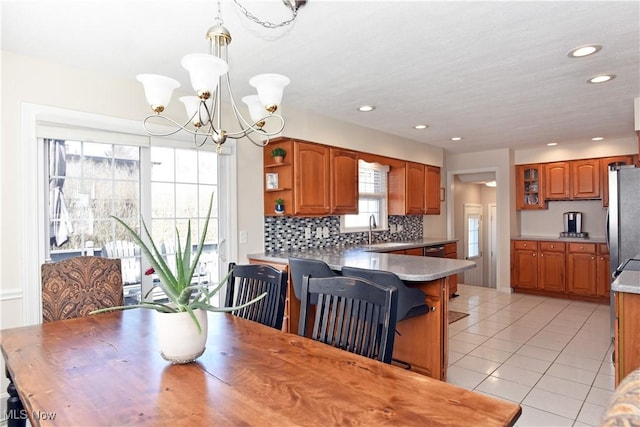 dining space featuring light tile patterned flooring, an inviting chandelier, and recessed lighting