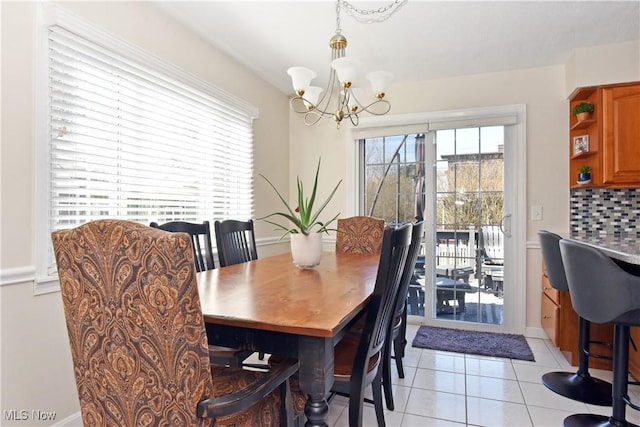 dining space featuring a notable chandelier and light tile patterned flooring