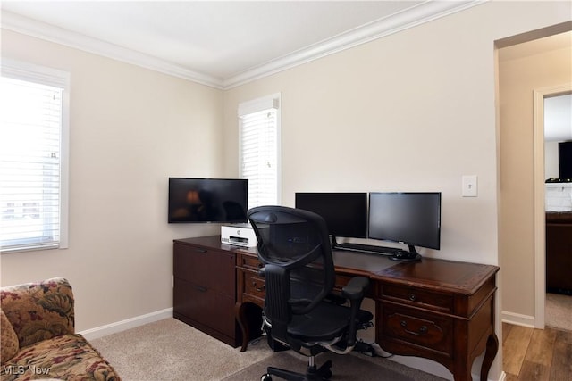 office space featuring baseboards, ornamental molding, and plenty of natural light