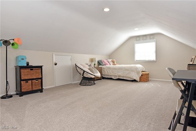 carpeted bedroom with baseboards and lofted ceiling