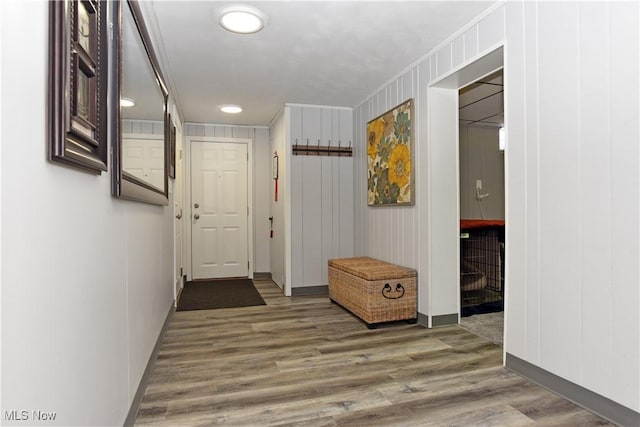 hall with baseboards and wood finished floors