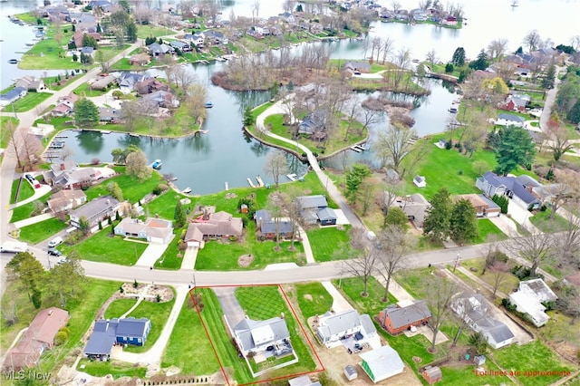 drone / aerial view featuring a water view and a residential view
