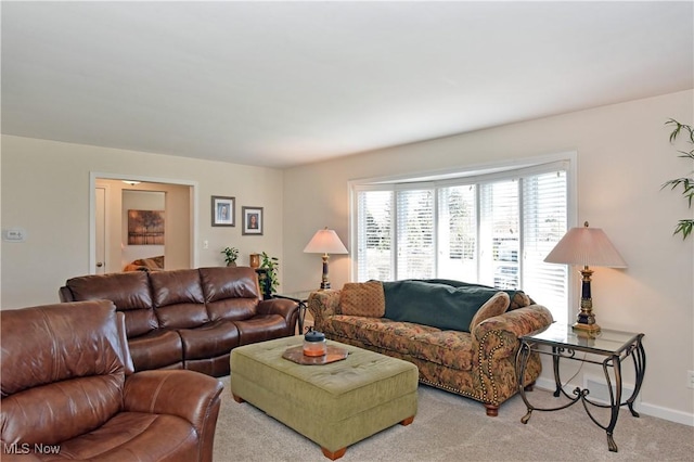 carpeted living room featuring baseboards