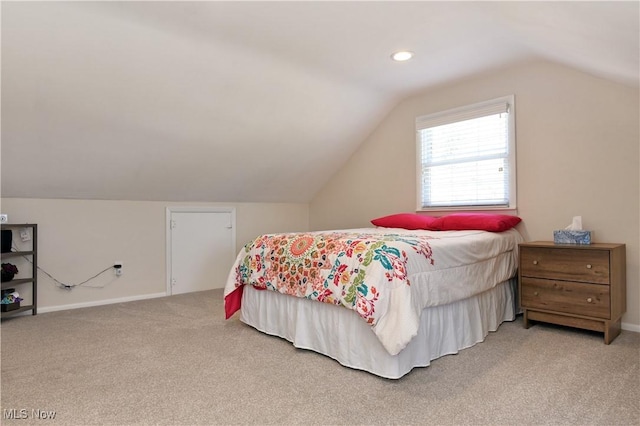 bedroom with light carpet, baseboards, and lofted ceiling