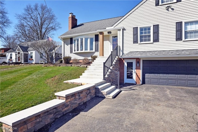 view of front facade featuring a chimney, an attached garage, a front lawn, aphalt driveway, and a shingled roof