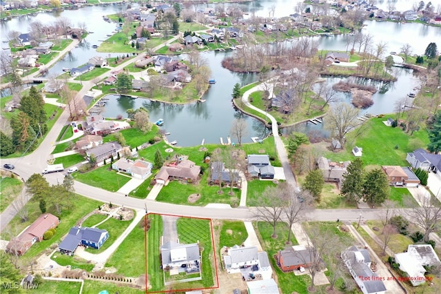 birds eye view of property with a water view and a residential view