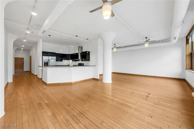 2077 E 4th St E Unit 4E, Cleveland, OH 44115 - unfurnished living room with rail lighting, light wood finished floors, baseboards, and a ceiling fan