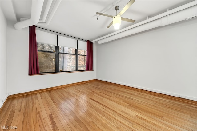 2077 E 4th St E Unit 4E, Cleveland, OH 44115 - empty room featuring baseboards, a ceiling fan, and wood finished floors