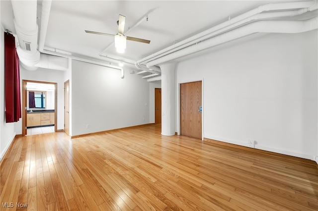 2077 E 4th St E Unit 4E, Cleveland, OH 44115 - empty room with light wood finished floors, ceiling fan, and baseboards