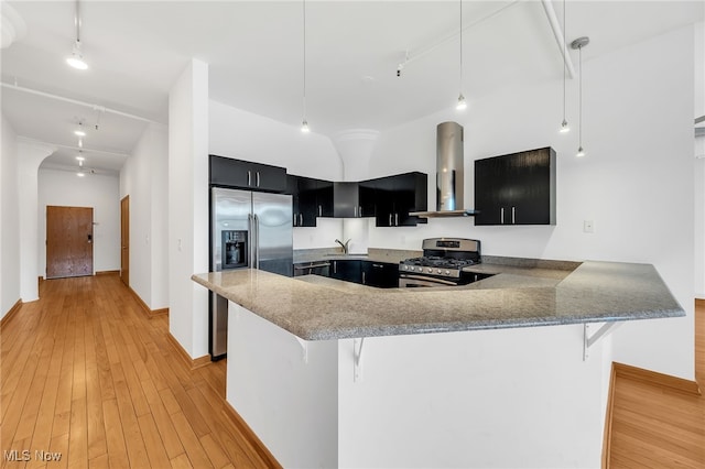 2077 E 4th St E Unit 4E, Cleveland, OH 44115 - kitchen featuring range hood, light wood-type flooring, a breakfast bar, stainless steel appliances, and dark cabinetry