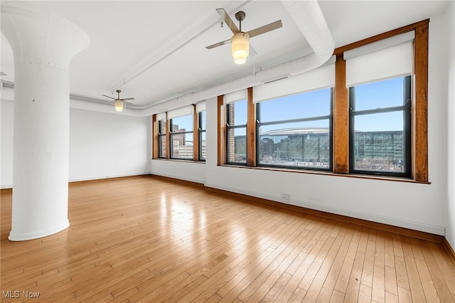 2077 E 4th St E Unit 4E, Cleveland, OH 44115 - spare room with ceiling fan, ornate columns, hardwood / wood-style floors, and baseboards