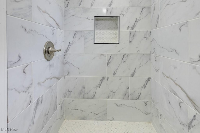 full bathroom with a tile shower