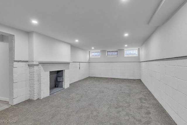 below grade area with a fireplace, carpet, and recessed lighting