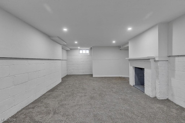 below grade area featuring recessed lighting, a fireplace, and carpet flooring