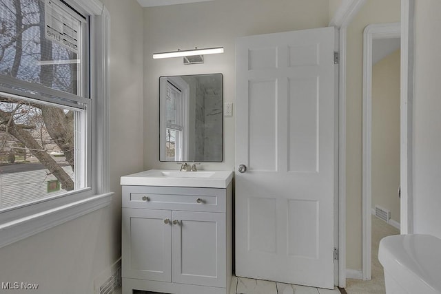 bathroom with visible vents, baseboards, and vanity