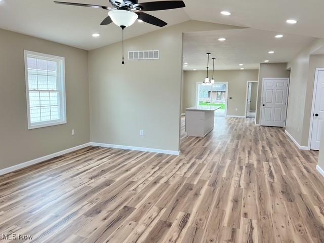 spare room featuring light wood-type flooring, visible vents, baseboards, ceiling fan, and recessed lighting