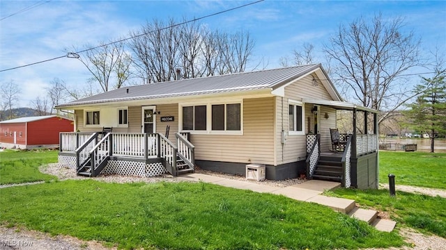 3020 State Route 376, Stockport, OH 43787 - view of front of property with a porch, metal roof, crawl space, and a front lawn