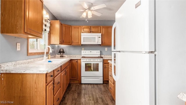 3020 State Route 376, Stockport, OH 43787 - kitchen featuring a sink, light countertops, ceiling fan, white appliances, and dark wood-type flooring