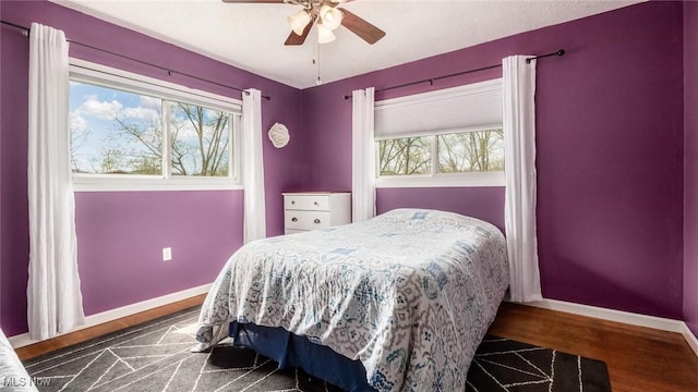 3020 State Route 376, Stockport, OH 43787 - bedroom featuring ceiling fan, multiple windows, baseboards, and wood finished floors
