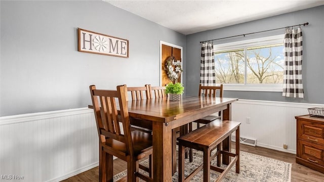 3020 State Route 376, Stockport, OH 43787 - dining space with wainscoting, visible vents, and wood finished floors