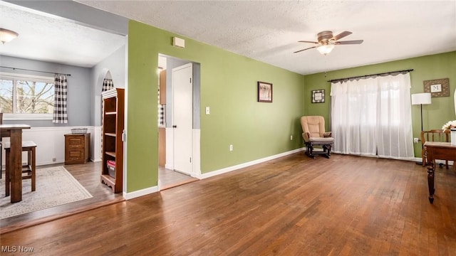 3020 State Route 376, Stockport, OH 43787 - living area featuring ceiling fan, baseboards, hardwood / wood-style flooring, and a textured ceiling