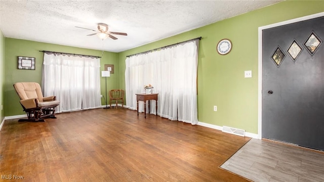 3020 State Route 376, Stockport, OH 43787 - unfurnished room featuring visible vents, ceiling fan, wood finished floors, and a textured ceiling