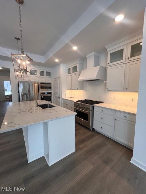 2176 Myla Way, Amherst, OH 44001 - kitchen featuring dark wood finished floors, stainless steel appliances, a sink, premium range hood, and white cabinetry