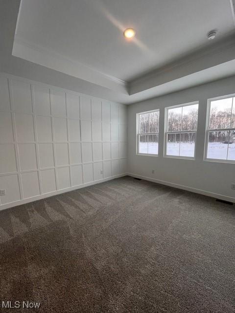 2176 Myla Way, Amherst, OH 44001 - empty room with dark carpet, baseboards, and a raised ceiling