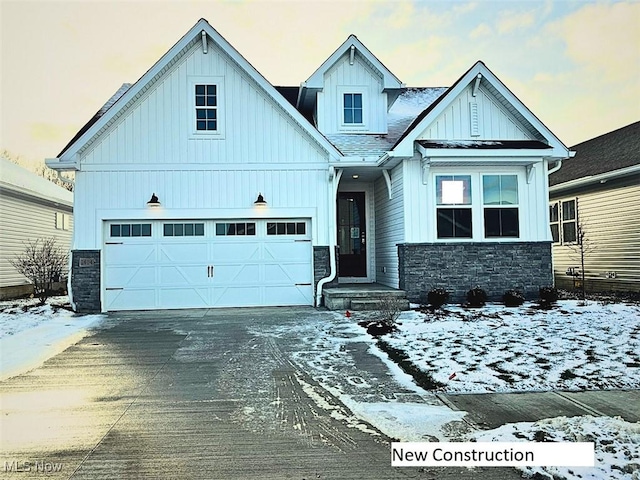 2176 Myla Way, Amherst, OH 44001 - craftsman-style house featuring driveway, stone siding, and board and batten siding