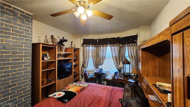 bedroom featuring brick wall and ceiling fan