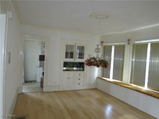 1831 Knowles St, East Cleveland, OH 44112 - unfurnished dining area with ornamental molding and light wood finished floors