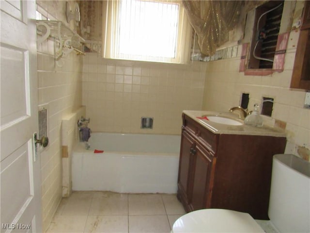 1831 Knowles St, East Cleveland, OH 44112 - full bath with vanity, tile patterned floors, toilet, a bath, and tile walls