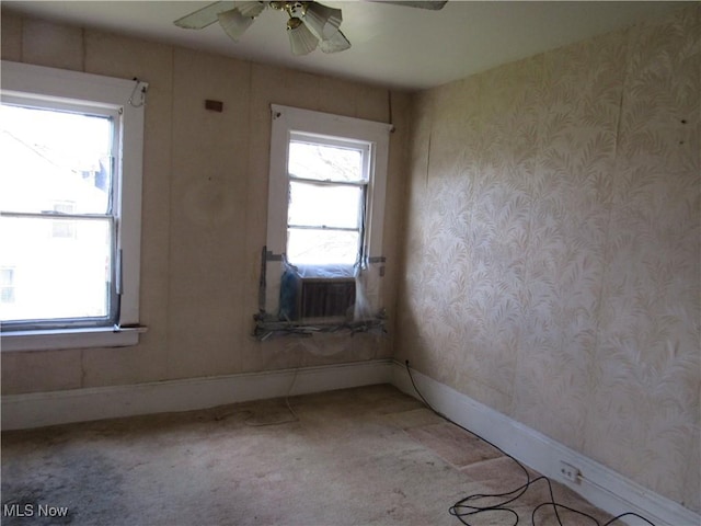 1831 Knowles St, East Cleveland, OH 44112 - empty room with light carpet, plenty of natural light, baseboards, and a ceiling fan