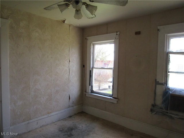 1831 Knowles St, East Cleveland, OH 44112 - carpeted empty room featuring a wealth of natural light, baseboards, and ceiling fan