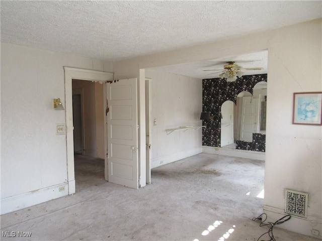 1831 Knowles St, East Cleveland, OH 44112 - interior space with ceiling fan, arched walkways, a textured ceiling, concrete flooring, and visible vents