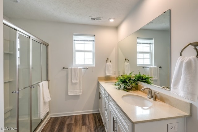 835-2 Dipper Ln, Aurora, OH 44202 - full bath with healthy amount of natural light, double vanity, wood finished floors, a textured ceiling, and a stall shower