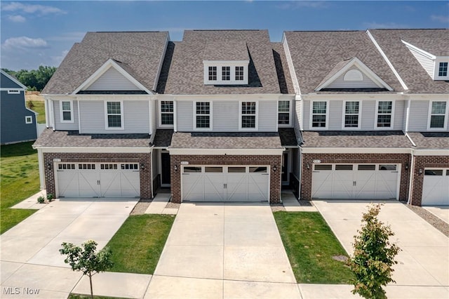 835-2 Dipper Ln, Aurora, OH 44202 - townhome / multi-family property with brick siding, concrete driveway, a garage, and a shingled roof
