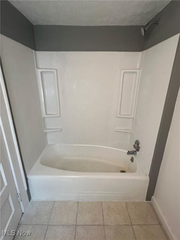 bathroom featuring tile patterned floors, a textured ceiling, and shower / bathtub combination