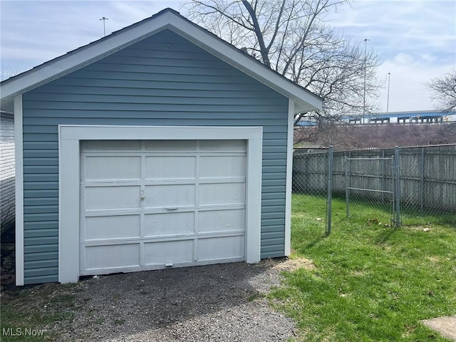 detached garage featuring fence