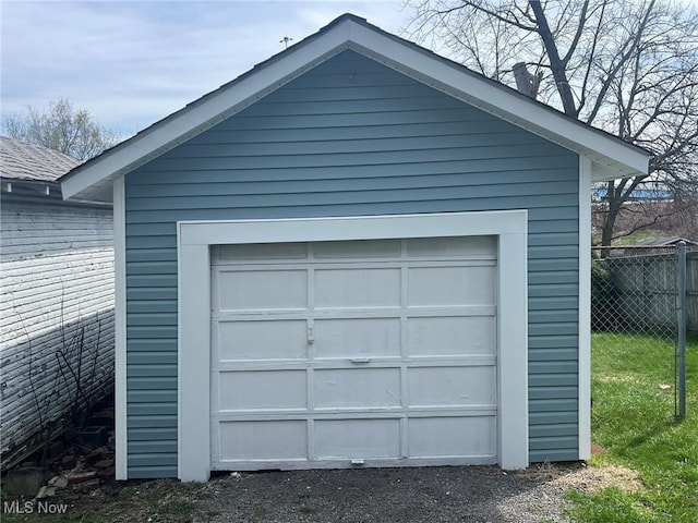 detached garage featuring fence
