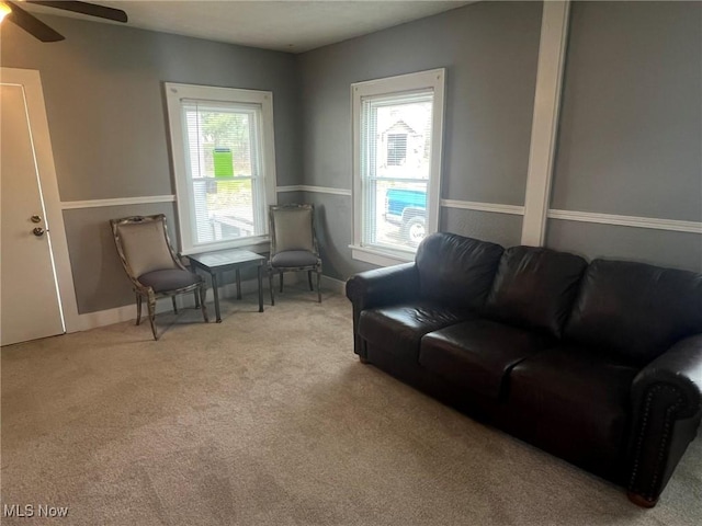 living room with a healthy amount of sunlight, carpet flooring, ceiling fan, and baseboards