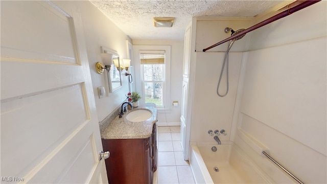 bathroom with a textured ceiling, vanity, shower / bath combination, and tile patterned flooring