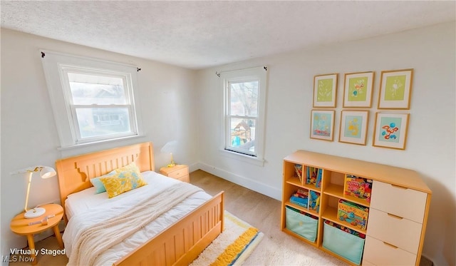 bedroom featuring a textured ceiling and baseboards